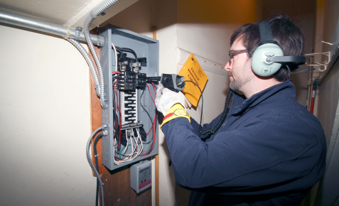 electrician inspecting electrical panel
