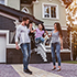 family standing in front of house