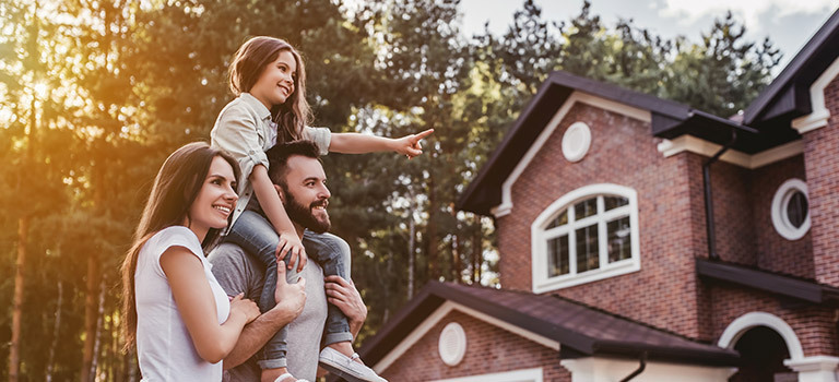 family in front of house